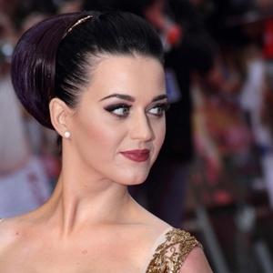 A street artist is suing the designer responsible for Katy Perry's May Met Ball dress for copyright infringement.