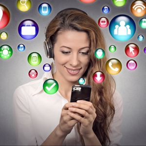 A business woman with phone in her hands and app icons surrounding here.