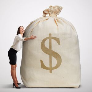 Business woman hugging a big cash bag.